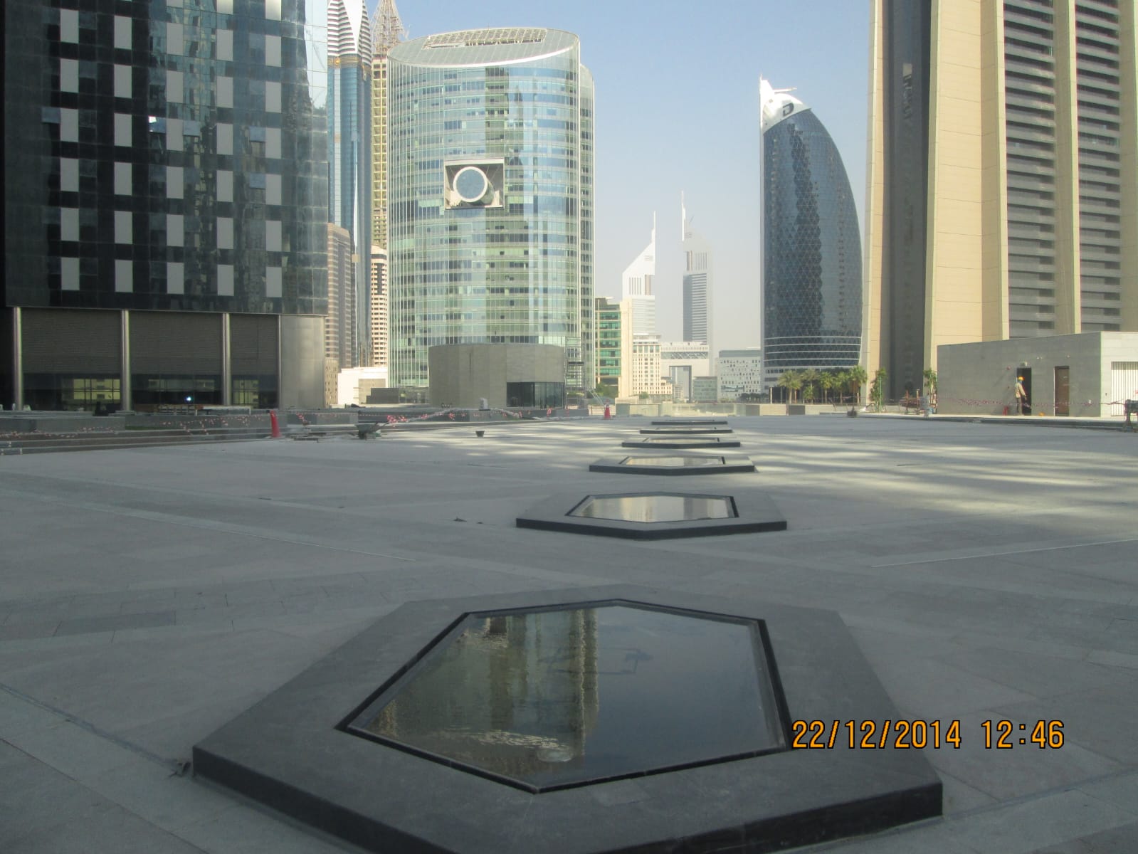 City-centre plaza paved in stone with black granite framed skylights