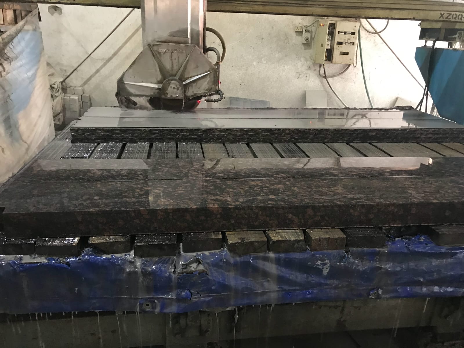 Fabricated granite pieces stacked and labelled in the workshop