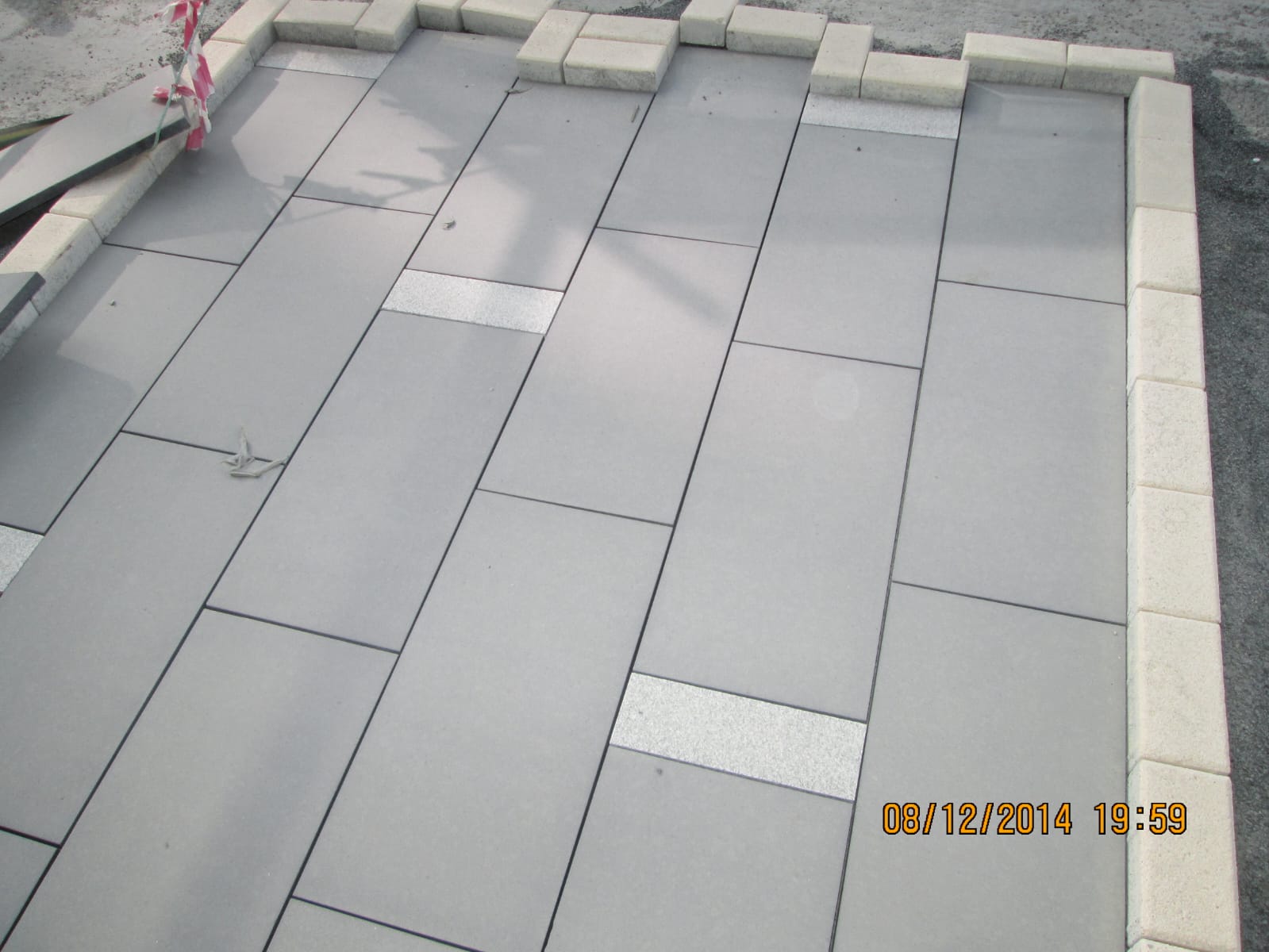 Large-format grey stone floor tiles laid with tight joints