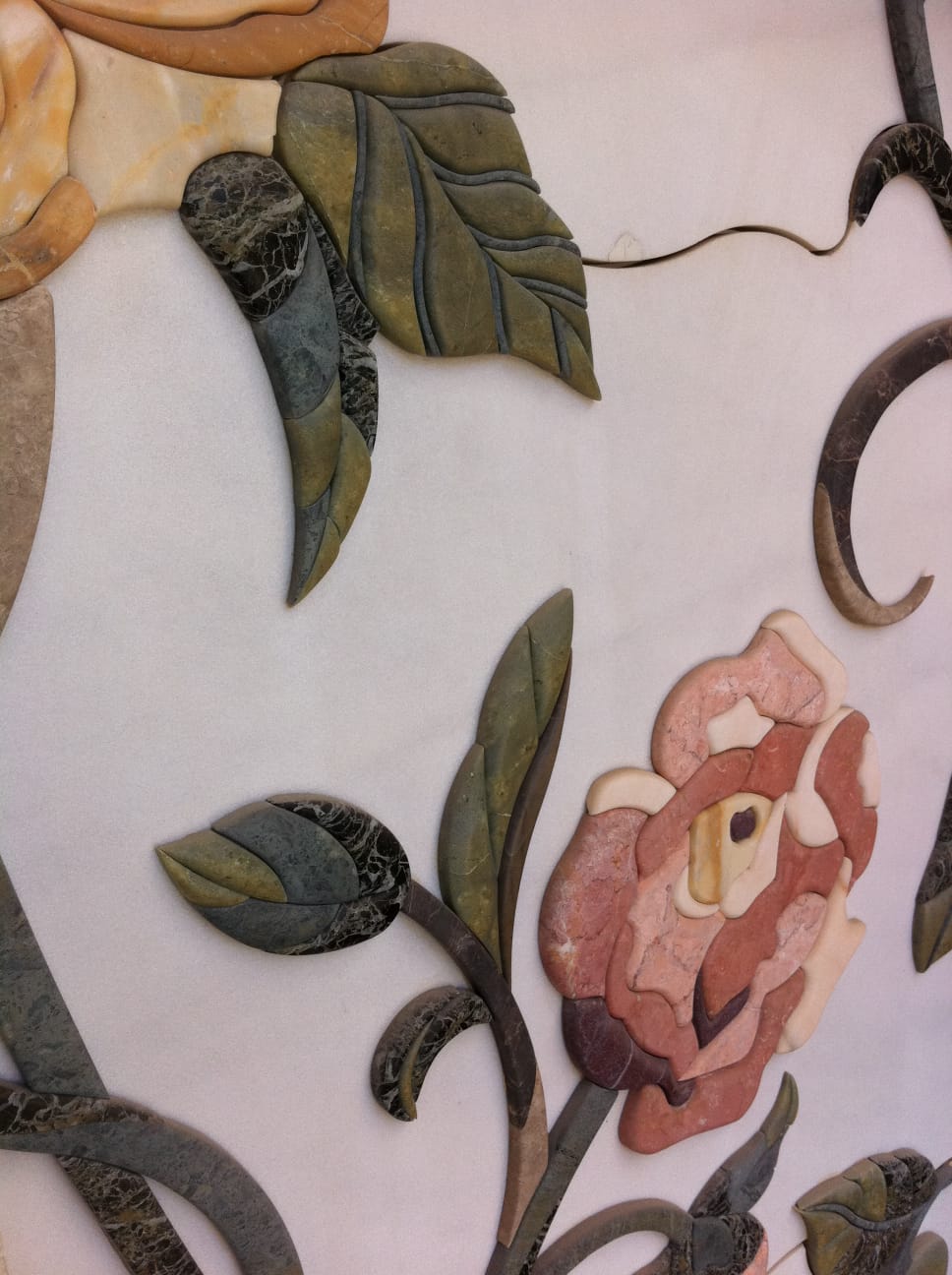 Hand-assembled floral marble inlay in coloured natural stone