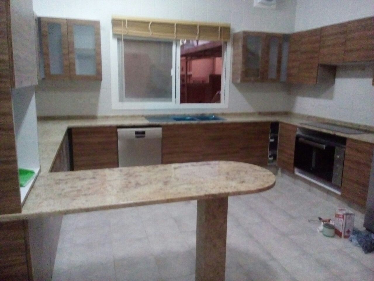 Kitchen with gold-toned granite countertops and a shaped breakfast bar