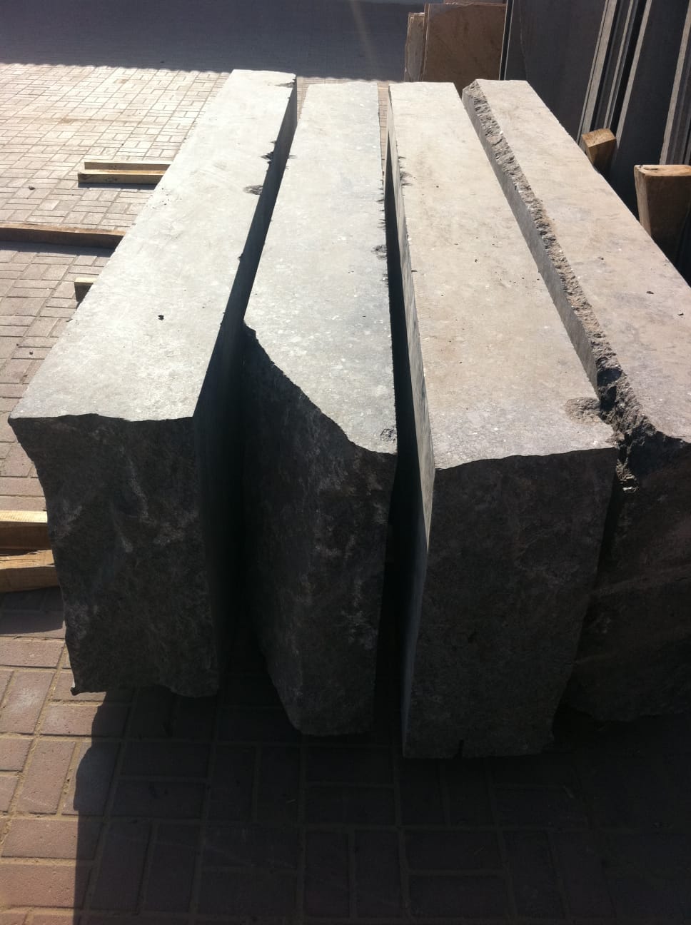 Rough split natural granite blocks staged before fabrication