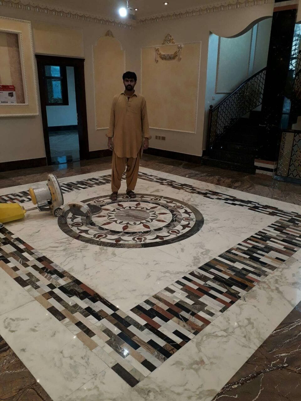 Waterjet marble medallion floor being polished on site during installation